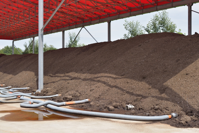 Aerate large compost piles with perforated pipes