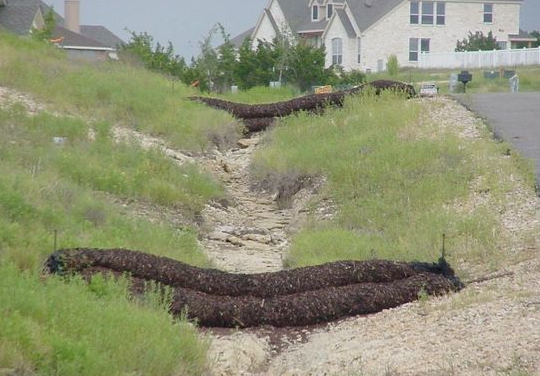 Soil berms set across a gully to control erosion
