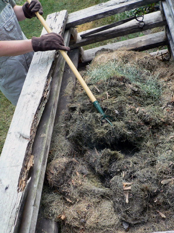 Manually turn small compost piles to increase oxygen content